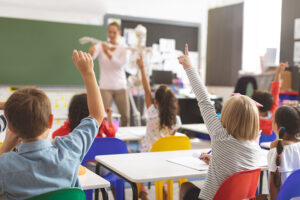 Kids raising hands in classroom in Carmel Indiana